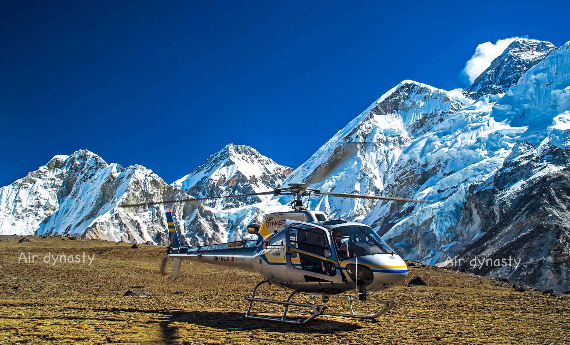 Air Dynasty Heli Services helicopter flying above the Himalayan mountains in Nepal